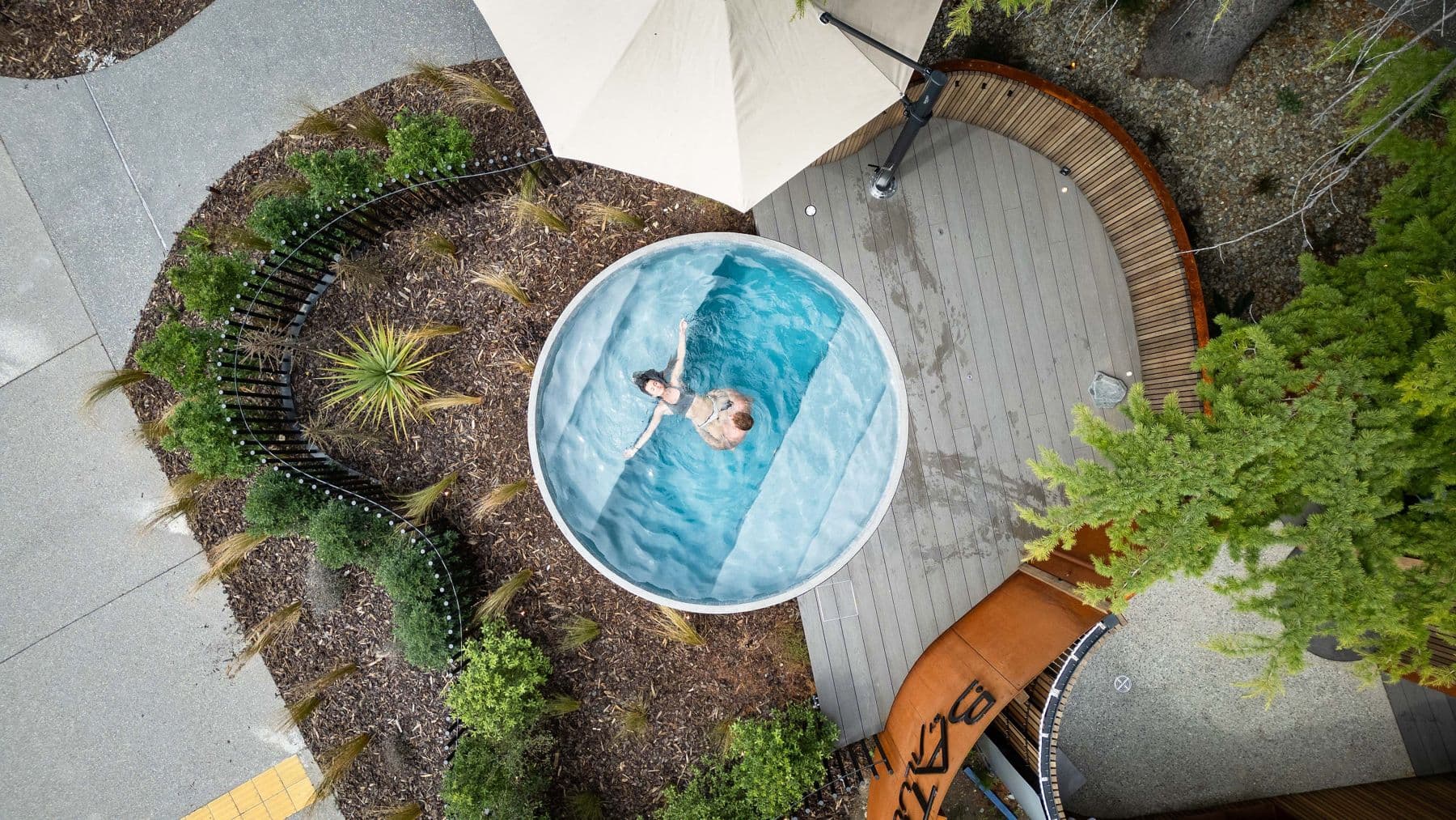 Looking down on a Bathe hot pool among the garden
